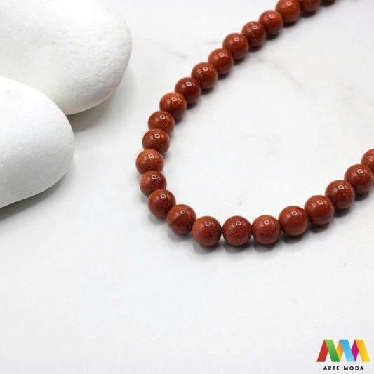 sunčev kamen poludragi sunca sunstone ljekovito kamenje kristali mineral nakit perle privjesci radost optimizam sreća energija pozitivnost meditaciju narukvica čakre prirodni sunca blistavi poludragi kamen toplom narančasto-zlatnom sjaju i inkluzijama koje podsjećaju na sunčeve zrake Sunčev kamen donosi radost optimizam i vitalnost te da pojačava osobnu snagu i karizmu izradu nakita koji zrači pozitivnom energijom i kao moćan saveznik u meditaciji za podizanje raspoloženja arte moda repromaterijal